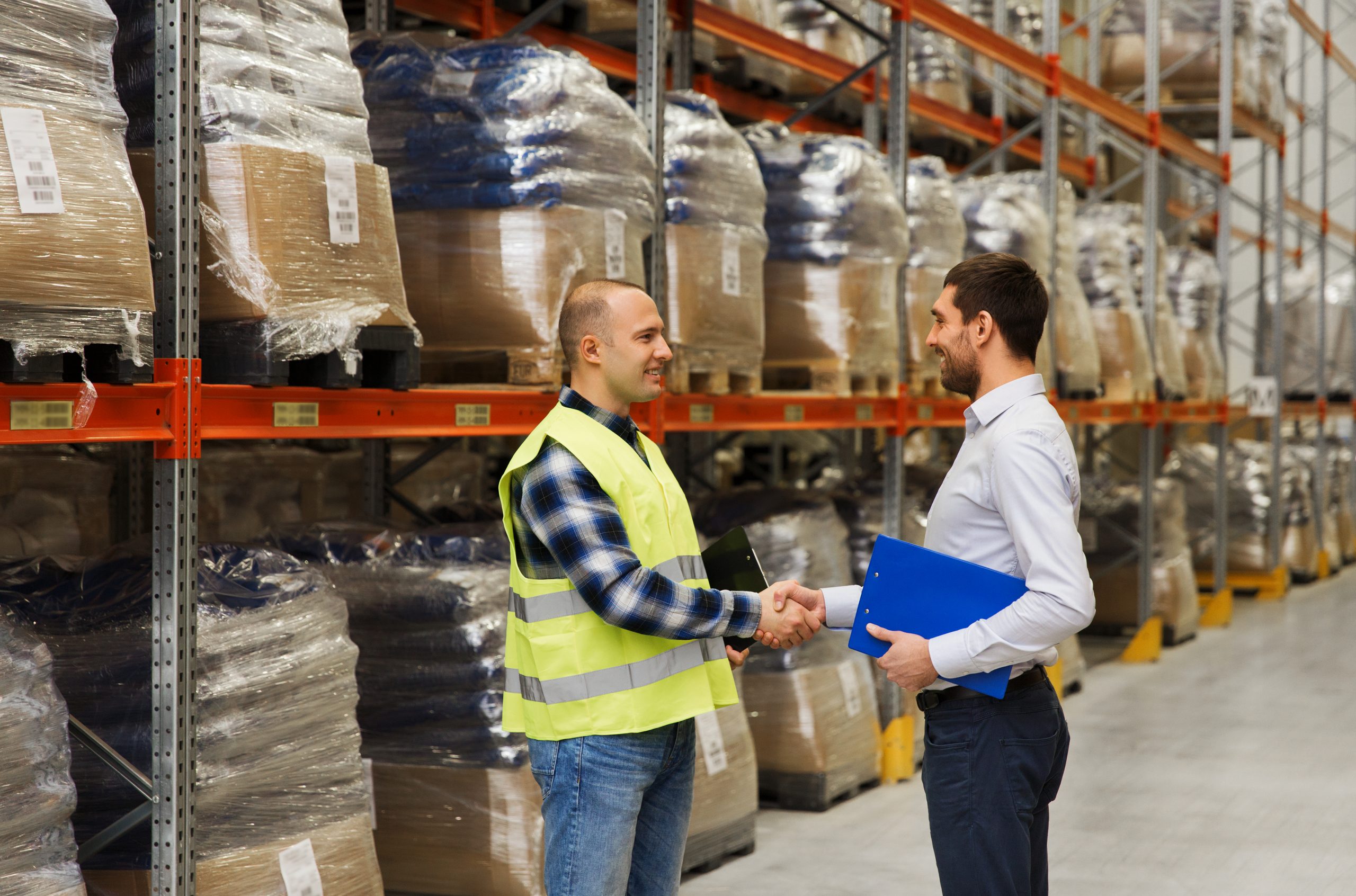 worker and businessmen with clipboard at warehouse